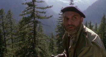 Movie still from “Harry and the Hendersons” (1987), directed by William Dear – A man with a beard wearing a hat and jacket; Close Up shot, Low angle