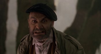 Movie still from “Harry and the Hendersons” (1987), directed by William Dear – An old man with a beard and a hat is making an angry face; Close Up shot, Low angle