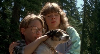 Movie still from “Harry and the Hendersons” (1987), directed by William Dear – Two women holding a dog in their arms; Close Up shot, Low angle