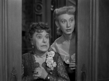 Movie still from “Harvey” (1950), directed by Henry Koster – Two women are standing next to each other; Medium shot, High angle