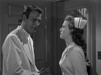 Movie still from “Harvey” (1950), directed by Henry Koster – A man and a woman talking to each other; Medium shot, Low angle