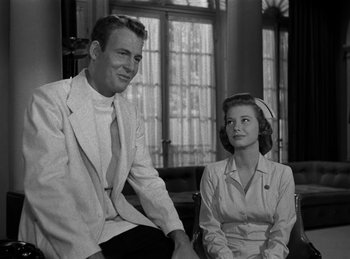 Movie still from “Harvey” (1950), directed by Henry Koster – A man and a woman sitting next to each other; Medium shot, Low angle