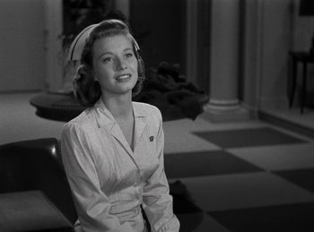Movie still from “Harvey” (1950), directed by Henry Koster – A black - and - white photo of a woman smiling; Medium shot, Low angle