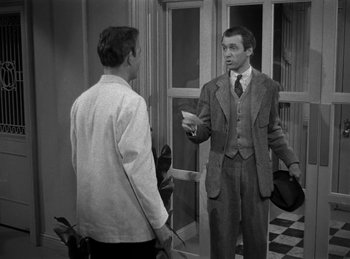 Movie still from “Harvey” (1950), directed by Henry Koster – Two men are talking in front of a building; Medium shot, Over the shoulder angle