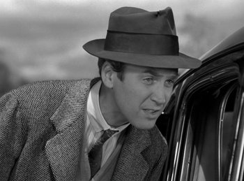 Movie still from “Harvey” (1950), directed by Henry Koster – A black and white photo of a man wearing a hat; Close Up shot, Over the shoulder angle