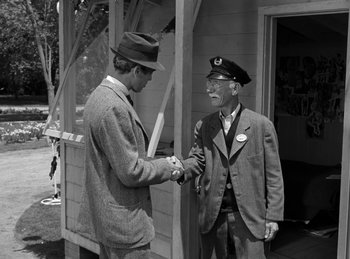 Movie still from “Harvey” (1950), directed by Henry Koster – Two men shaking hands in front of a building; Medium shot, Over the shoulder angle