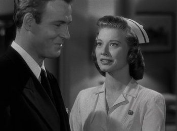 Movie still from “Harvey” (1950), directed by Henry Koster – A man standing next to a woman wearing a nurse's hat; Close Up shot, Low angle
