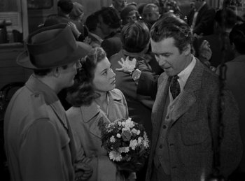 Movie still from “Harvey” (1950), directed by Henry Koster – A group of people standing next to each other holding flowers; Medium shot, Over the shoulder angle