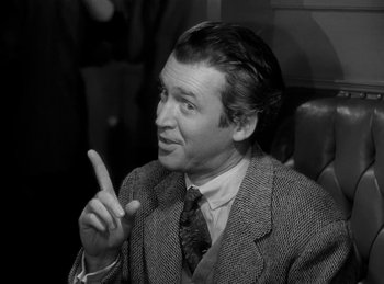 Movie still from “Harvey” (1950), directed by Henry Koster – A black and white photo of a man in a suit and tie; Close Up shot, Over the shoulder angle