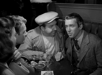 Movie still from “Harvey” (1950), directed by Henry Koster – A group of men sitting at a table with wine glasses; Medium shot, Over the shoulder angle