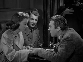 Movie still from “Harvey” (1950), directed by Henry Koster – A group of people sitting around a table; Medium shot, Over the shoulder angle