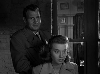 Movie still from “Harvey” (1950), directed by Henry Koster – A man standing next to a woman in front of a window; Close Up shot, Over the shoulder angle