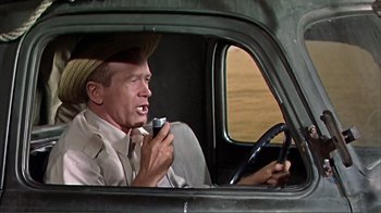 Movie still from “Hatari!” (1962), directed by Howard Hawks – An old man in a hat driving a truck; Medium shot, Low angle