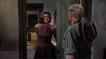 Movie still from “Hatari!” (1962), directed by Howard Hawks – A man and a woman standing next to each other in a doorway; Medium shot, Over the shoulder angle