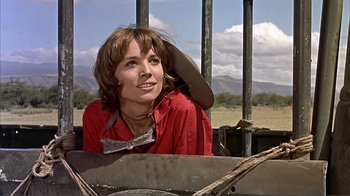 Movie still from “Hatari!” (1962), directed by Howard Hawks – A woman sitting in the back of a truck; Medium shot, Low angle