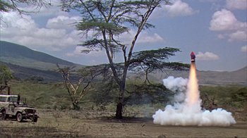 Movie still from “Hatari!” (1962), directed by Howard Hawks – An image of a rocket launch in the middle of a field; Extreme Wide shot, Low angle