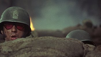 Movie still from “Head” (1968), directed by Bob Rafelson – A soldier's helmet on a cloudy day; Close Up shot, Low angle