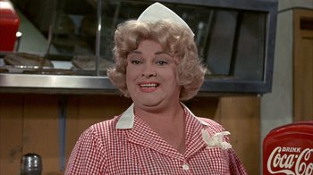 Movie still from “Head” (1968), directed by Bob Rafelson – A person wearing a nurse's outfit; Close Up shot, Over the shoulder angle