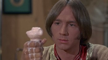 Movie still from “Head” (1968), directed by Bob Rafelson – A man holding an ice cream cone in his hand; Close Up shot, High angle
