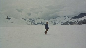 Movie still from “Head” (1968), directed by Bob Rafelson – A person standing in the middle of a snow covered field; Extreme Wide shot, High angle