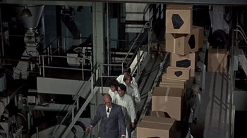 Movie still from “Head” (1968), directed by Bob Rafelson – A group of people walking down a set of stairs; Wide shot, High angle