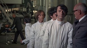 Movie still from “Head” (1968), directed by Bob Rafelson – A group of men in white lab coats standing in a line; Medium shot, Low angle