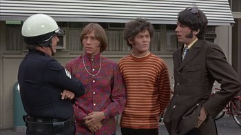 Movie still from “Head” (1968), directed by Bob Rafelson – A group of men standing next to each other; Medium shot, Low angle