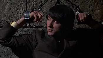 Movie still from “Head” (1968), directed by Bob Rafelson – A man holding on to a pair of handcuffs; Close Up shot, High angle