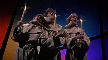 Movie still from “Head” (1968), directed by Bob Rafelson – A group of people holding lit candles in their hands; Medium shot, Low angle