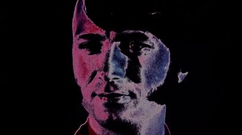 Movie still from “Head” (1968), directed by Bob Rafelson – A painting of a man in a cowboy hat; Extreme Close Up shot, Low angle