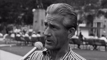 Movie still from “Head” (1968), directed by Bob Rafelson – An older man holding a microphone in his mouth; Close Up shot, Low angle