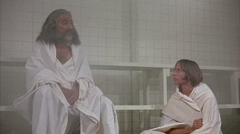 Movie still from “Head” (1968), directed by Bob Rafelson – A man and a woman sitting next to each other in a room; Medium shot, Low angle