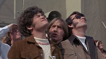 Movie still from “Head” (1968), directed by Bob Rafelson – A group of men standing next to each other; Medium shot, Low angle