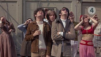 Movie still from “Head” (1968), directed by Bob Rafelson – A group of men standing next to each other; Medium shot, Low angle