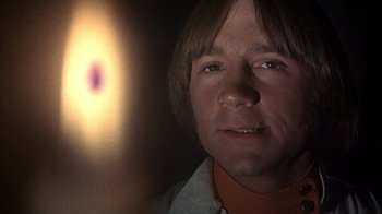 Movie still from “Head” (1968), directed by Bob Rafelson – A man's face in front of a blurry background; Close Up shot, Low angle