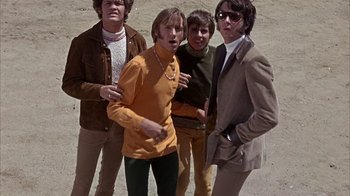 Movie still from “Head” (1968), directed by Bob Rafelson – A group of young men standing next to each other; Medium shot, Low angle