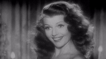 Movie still from “Head” (1968), directed by Bob Rafelson – An old black and white photo of a woman smiling; Close Up shot, Low angle