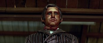 Movie still from “Heartbeeps” (1981), directed by Allan Arkush – The face of a wax statue of a man; Close Up shot, Low angle