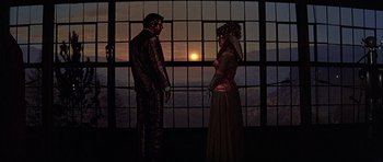 Movie still from “Heartbeeps” (1981), directed by Allan Arkush – A man and a woman standing next to each other; Wide shot, Low angle