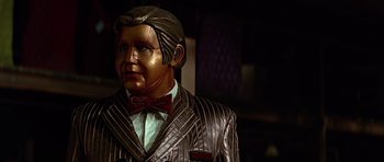 Movie still from “Heartbeeps” (1981), directed by Allan Arkush – A statue of a man wearing a suit; Close Up shot, Low angle