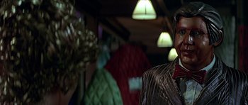 Movie still from “Heartbeeps” (1981), directed by Allan Arkush – A man standing in front of a bunch of lights; Close Up shot, Over the shoulder angle