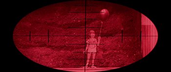 Movie still from “Heartbeeps” (1981), directed by Allan Arkush – A person holding a balloon in a red light; Wide shot, High angle