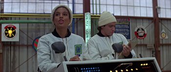 Movie still from “Heartbeeps” (1981), directed by Allan Arkush – Two women are sitting in front of a computer screen; Medium shot, Low angle