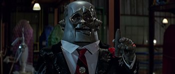 Movie still from “Heartbeeps” (1981), directed by Allan Arkush – A man in a suit and tie holding a cell phone; Close Up shot, Low angle