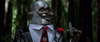 Movie still from “Heartbeeps” (1981), directed by Allan Arkush – A person wearing a suit and tie; Close Up shot, Low angle