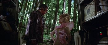 Movie still from “Heartbeeps” (1981), directed by Allan Arkush – A man and a woman dressed in costumes in a forest; Medium shot, Over the shoulder angle