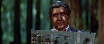 Movie still from “Heartbeeps” (1981), directed by Allan Arkush – A statue of a man in a suit and tie; Close Up shot, High angle