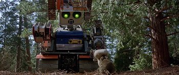 Movie still from “Heartbeeps” (1981), directed by Allan Arkush – A cat sitting in front of a large robot; Close Up shot, Low angle