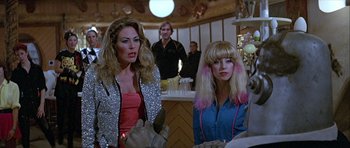 Movie still from “Heartbeeps” (1981), directed by Allan Arkush – Two women are sitting at a counter in front of a man; Medium shot, Over the shoulder angle