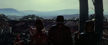 Movie still from “Heartbeeps” (1981), directed by Allan Arkush – A man and a woman standing in front of a pile of trash; Extreme Wide shot, Low angle
